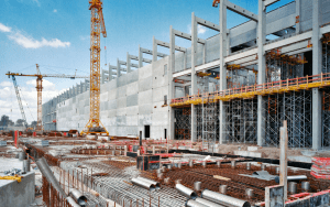 Construction site under development with scaffolding and equipment, a high-risk zone protected by remote video surveillance and AI-powered off-site monitoring systems like EyeQ’s virtual guard solution.