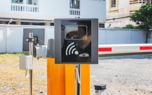 RFID-based access control system at a gated parking entrance, representing physical security measures against tailgating piggybacking. The system is designed to verify vehicle or personnel access and prevent unauthorized entry by blocking follow-ins.