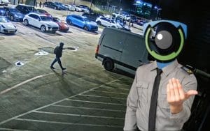 AI-powered security monitoring at an auto dealership: A masked virtual guard, representing EyeQ Monitoring, issues a live voice deterrent to a trespasser in a dealership lot at night. The image highlights the importance of AI-driven surveillance, real-time security alerts, and proactive theft prevention for car dealerships.