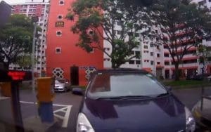 A security camera captures a person tailgating into an apartment building, illustrating the dangers of unauthorized access. The image highlights a common security risk where individuals sneak in behind residents without key fob authentication. Prevent tailgating with AI-powered video surveillance and live monitoring solutions like EyeQ Virtual Guard to enhance apartment security.